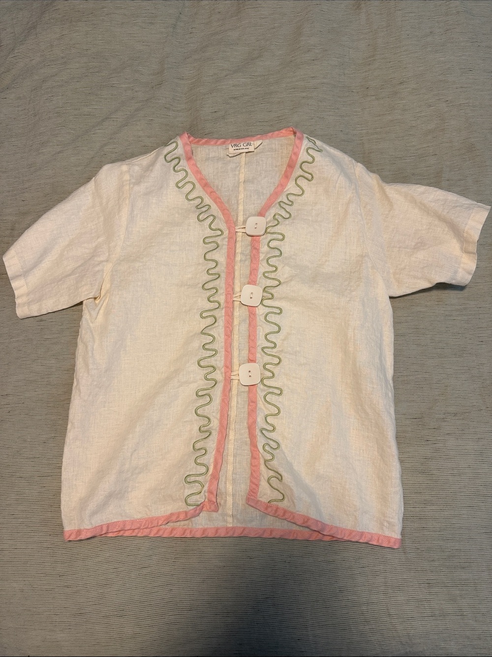 Cream Short-Sleeve Top with Pink Trim and Green Accents